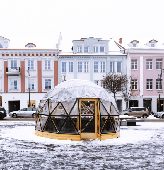 Small decorated wooden Christmas Market house covered with snow in Vilnius Town Hall square